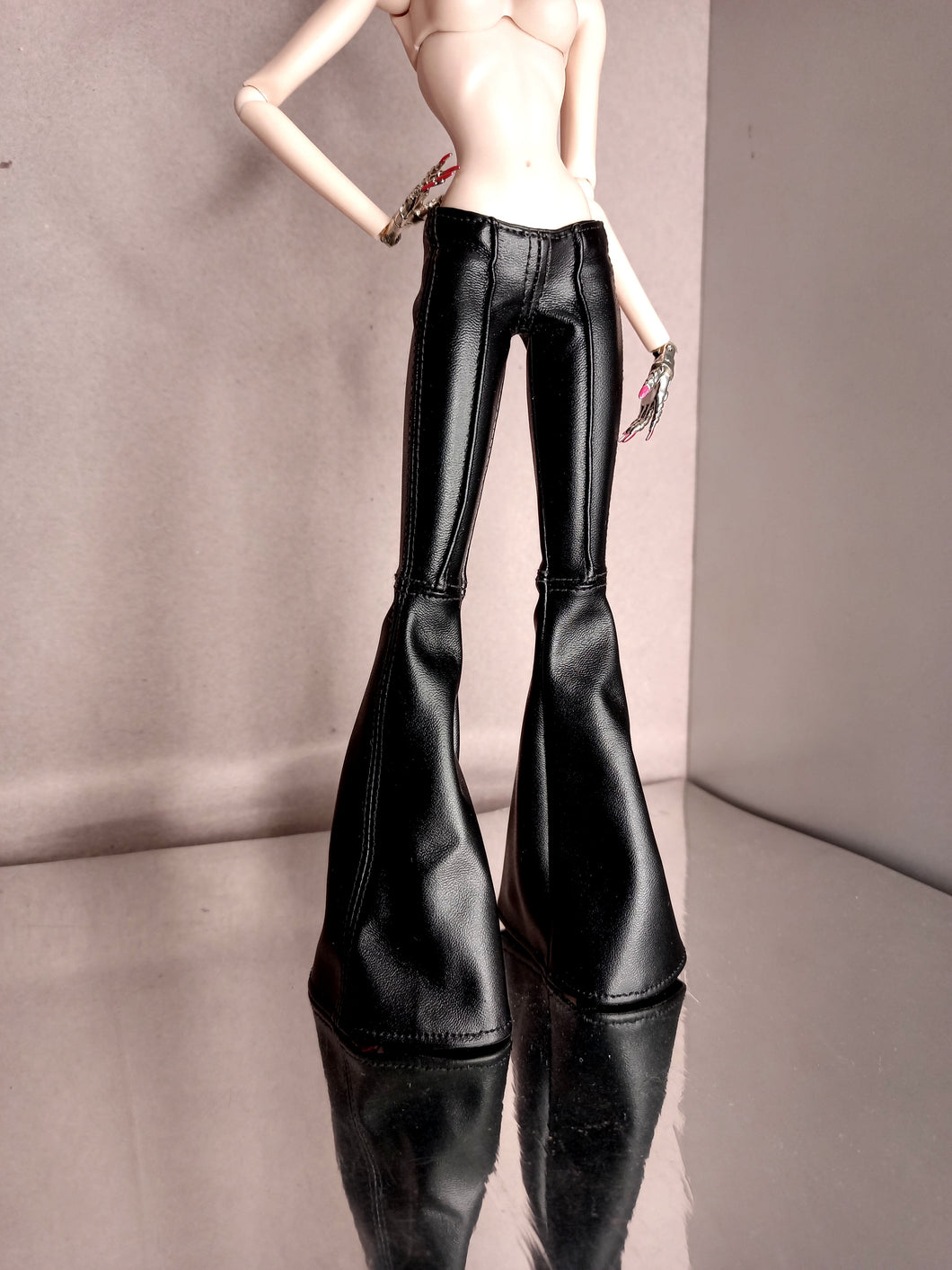 Low rise flaired pants in black faux leather