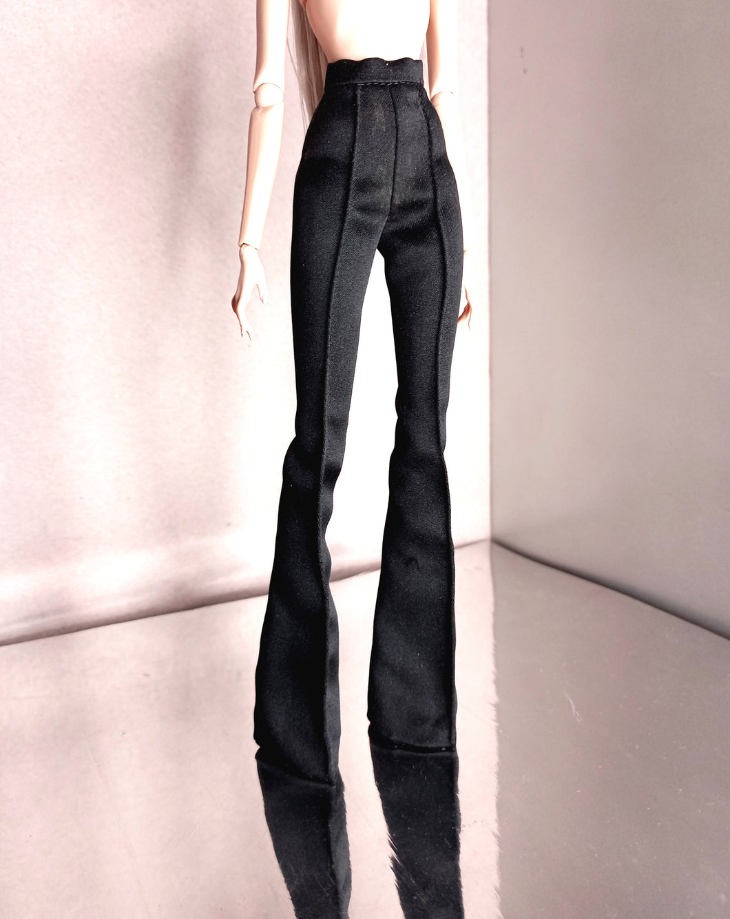 Black satin high-waisted flared pants.